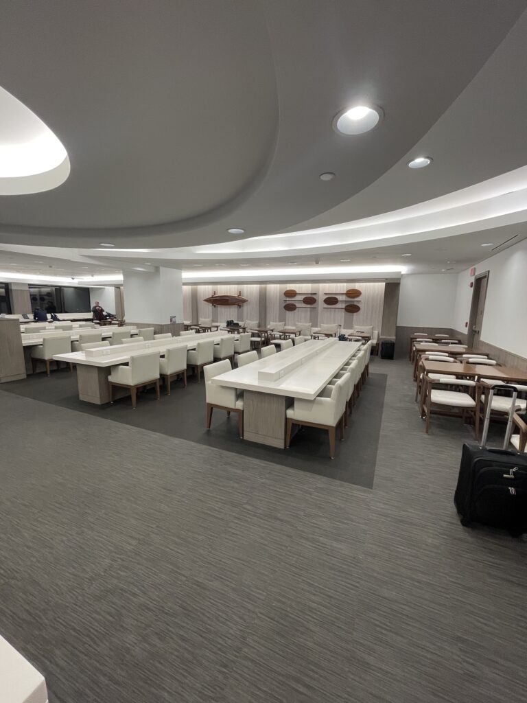 Honolulu Admirals Club | Guide & Review (2025) Hawaii Calling a room with white tables and chairs