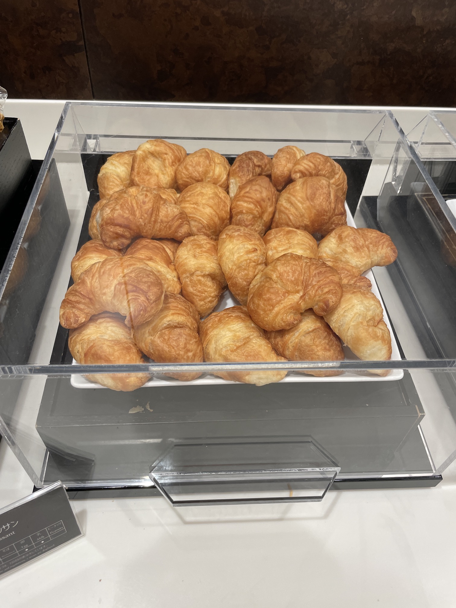 Honolulu Admirals Club | Guide & Review (2025) Hawaii Calling a tray of croissants in a clear container