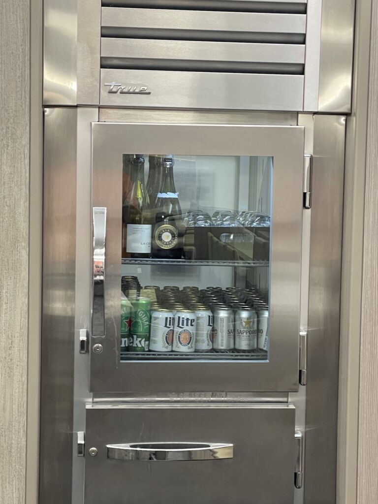 Honolulu Admirals Club | Guide & Review (2025) Hawaii Calling a refrigerator with drinks and cans