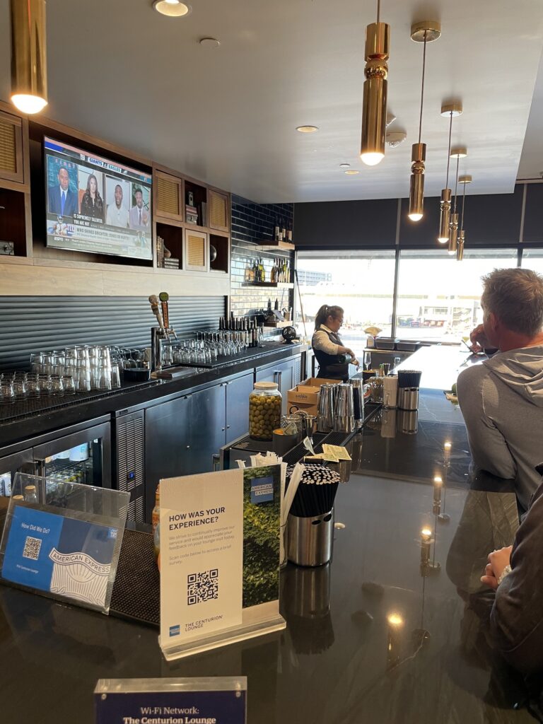 Review: American Express Centurion Lounge Phoenix - Small & Efficient Hawaii Calling a bar with a woman behind it
