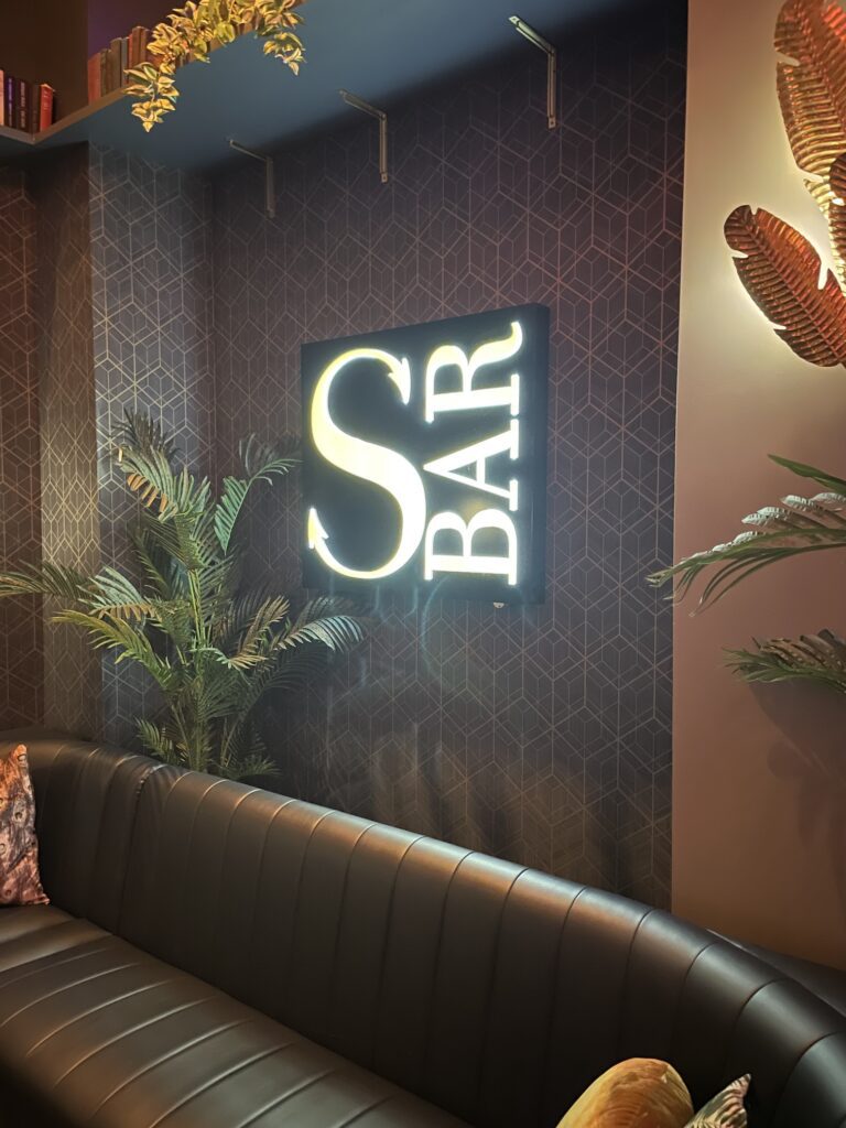 Review: Sexy Sultry S Bar Las Vegas Hawaii Calling a couch with a neon sign on the wall