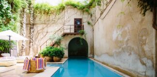 How to Use Credit Cards to Earn Free Hotel Nights Hotel Pool Stucco Walls Lounge area