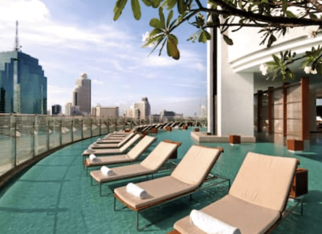 5 Amazing Bangkok Hotels on the River (2025) Hawaii Calling Millenium-Hilton-Bangkok-riverside-pool-chairs