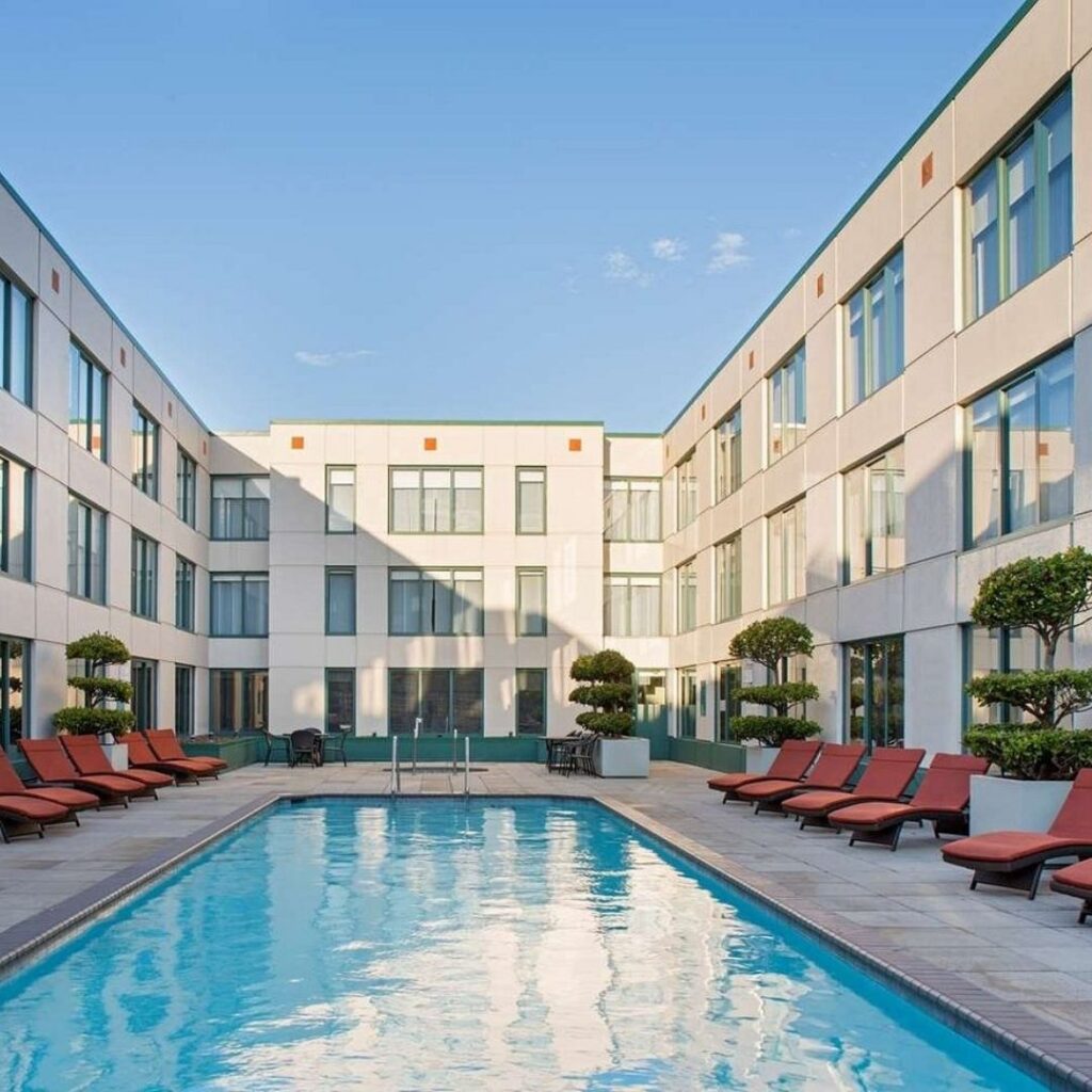 10 Best Hotels in Fisherman's Wharf, San Francisco Hawaii Calling a pool with lounge chairs in front of a building