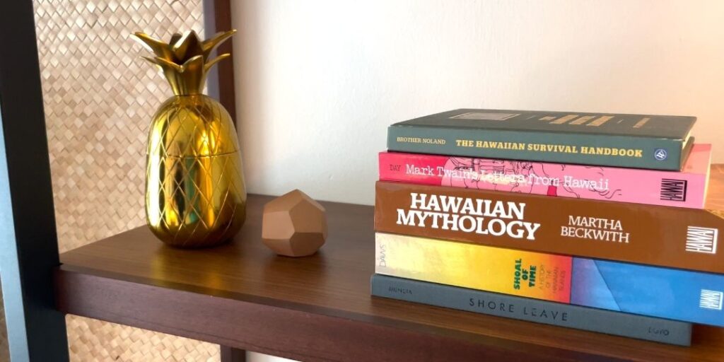 Review & Video: The Laylow Waikiki, Autograph Collection in Waikiki, Unique and Fun Hawaii Calling a pineapple and a stack of books