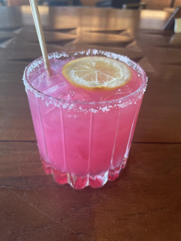 Review & Video: Mauna Kea Beach Hotel, Autograph Collection Hawaii Calling a glass of pink drink with a lemon slice and sugar rim