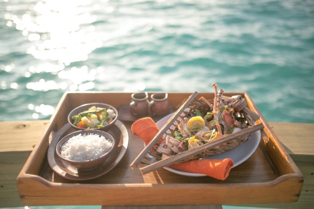 Virtuoso Travel: A Guide To Exclusive Perks & Benefits Hawaii Calling a tray of food on a table