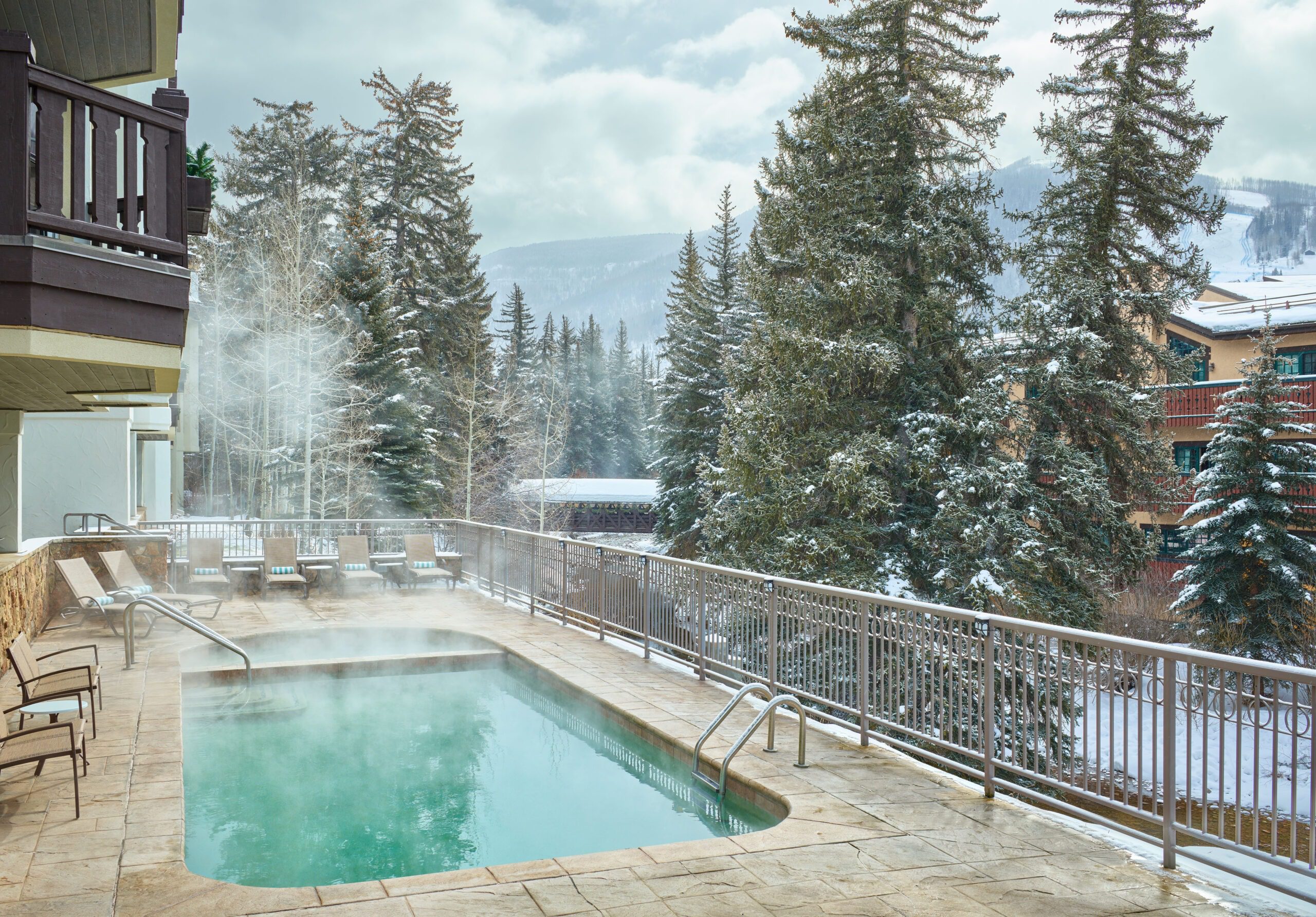Hyatt Austria Haus Hotel Opens in Vail, Colorado Hawaii Calling a pool with hot water and trees in the background