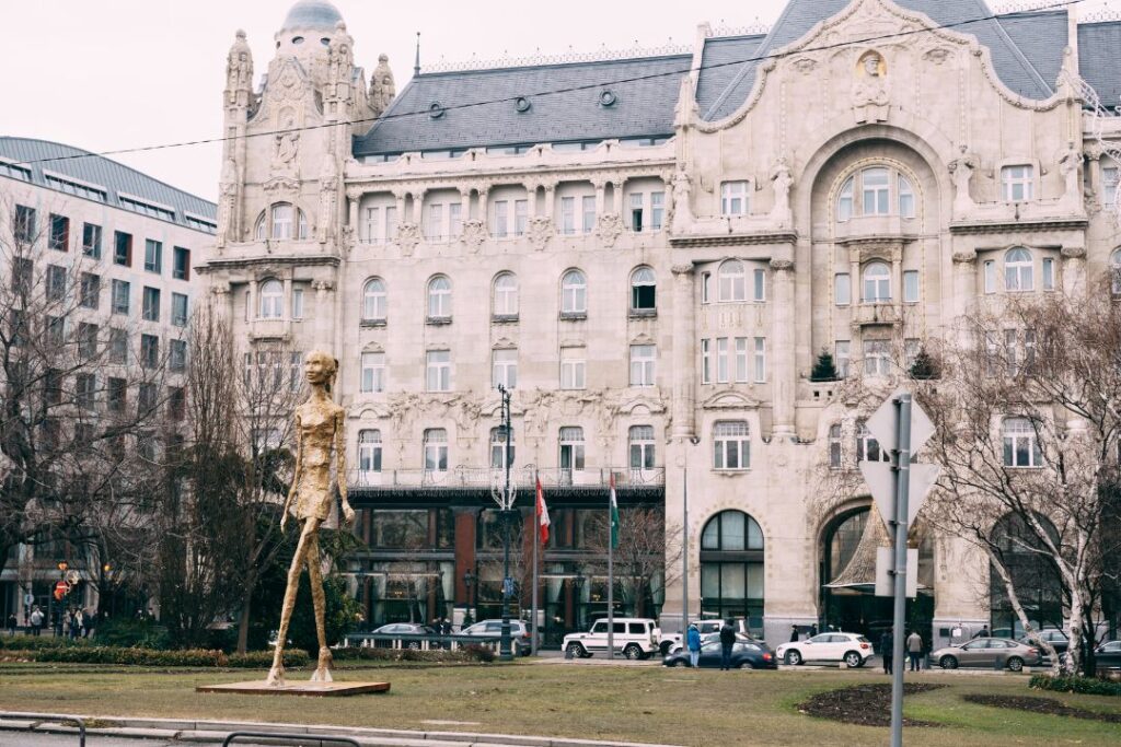 The Exclusive Four Seasons Preferred Partner Program Hawaii Calling a statue in front of a large building