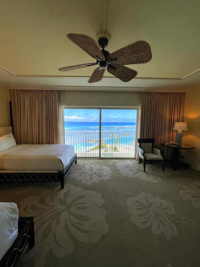 Review & Video: The Kahala Hotel and Resort, Presidential Luxury Hawaii Calling a room with a bed and a ceiling fan and a window with a view of the ocean