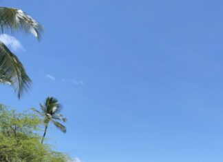 The Perfect Oahu 7 Day Budget Itinerary (2026) a body of water with a body of water and a beach with a mountain in the background