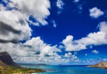 Luxury Oahu 7 Day Itinerary (2026) a beach with a sandy beach and mountains