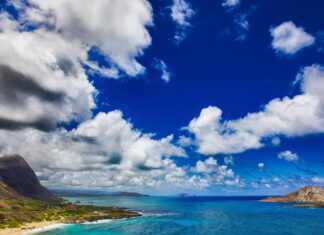 Luxury Oahu 7 Day Itinerary (2026) a beach with a sandy beach and mountains