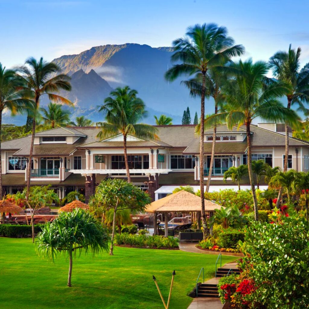 5 Best Luxury Hotels on Kauai (2025) Hawaii Calling a large building with palm trees and a lawn