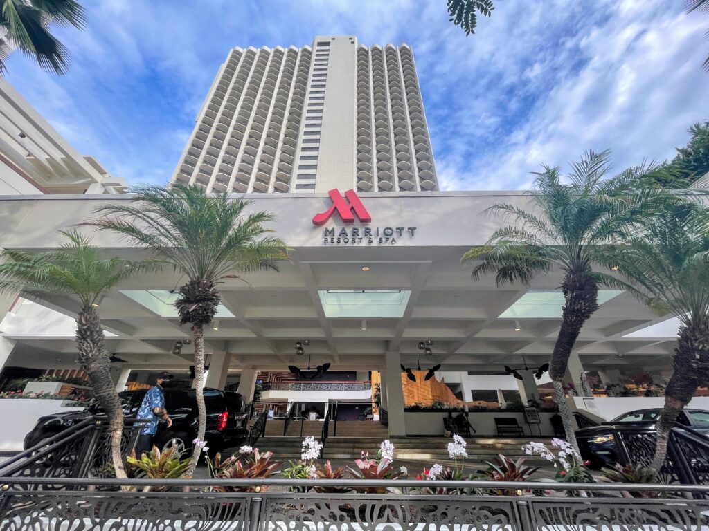 The 15 Best Hotels On Oahu For Families 2025 Hawaii Calling a building with palm trees and a sign