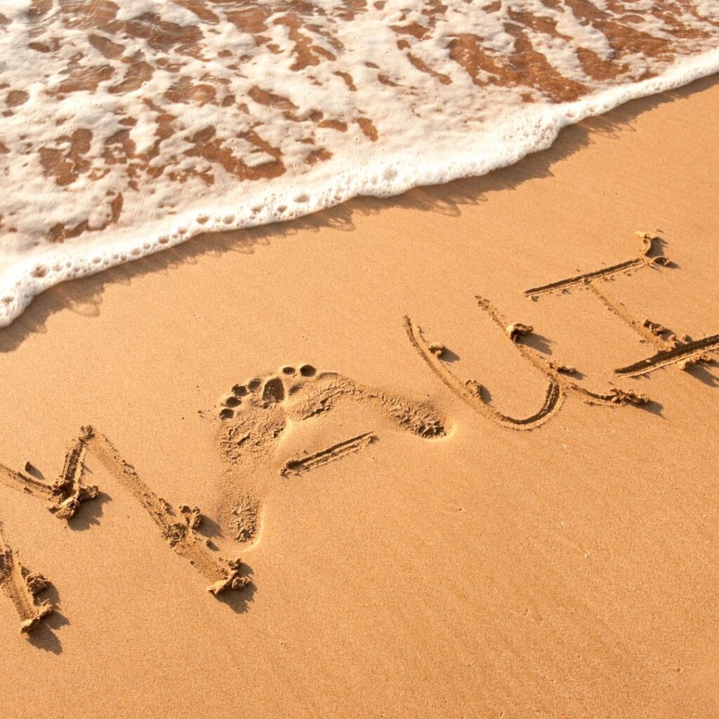 The Ultimate Maui Travel Guide 2023 Hawaii Calling a beach with waves and words written in sand