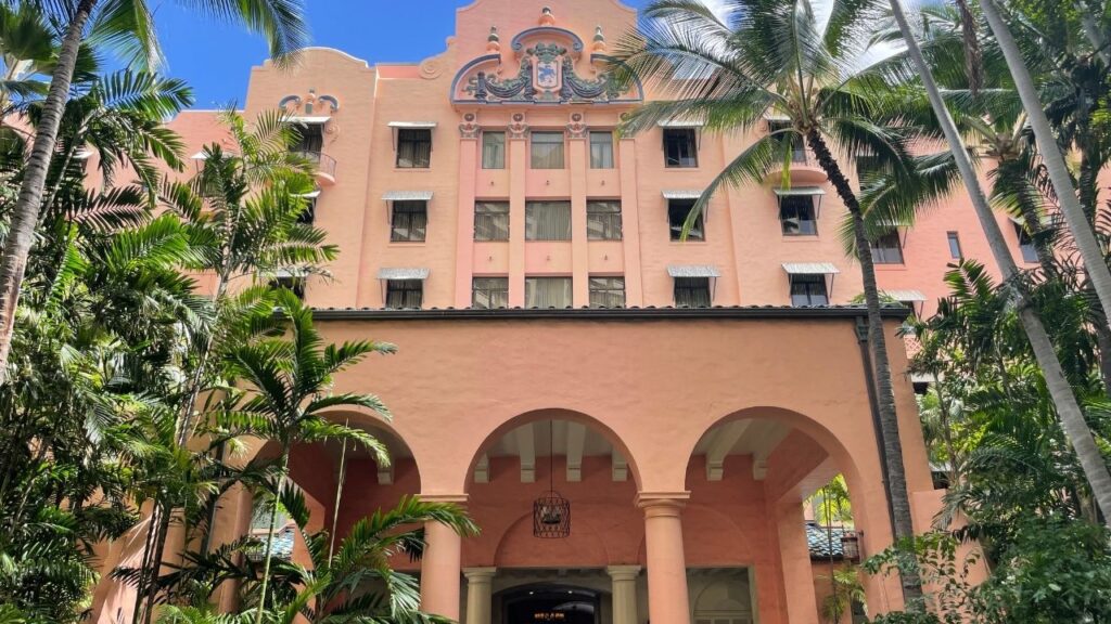 The 15 Best Hotels On Oahu For Families 2025 Hawaii Calling a pink building with palm trees