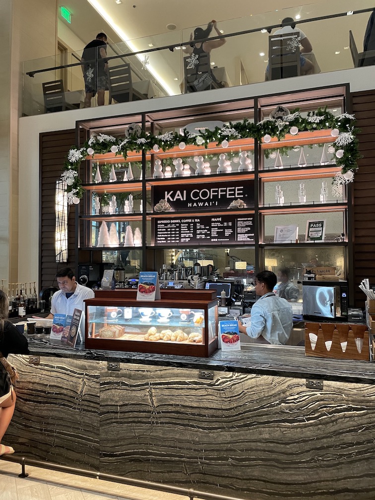 Review & Video: 'Alohilani Resort Waikiki Beach, A Unique Oasis Hawaii Calling a counter with a bar and people behind it