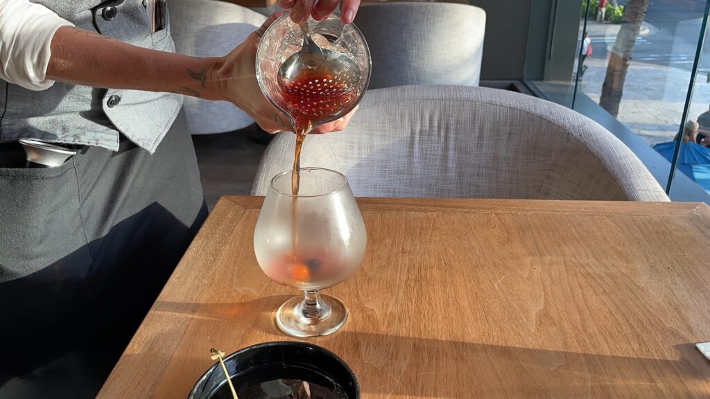 Review & Video: 'Alohilani Resort Waikiki Beach, A Unique Oasis Hawaii Calling a person pouring liquid into a glass