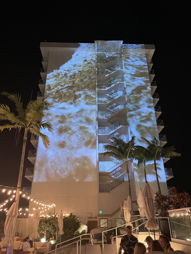 Review & Video: 'Alohilani Resort Waikiki Beach, A Unique Oasis Hawaii Calling a building with a projector on the wall