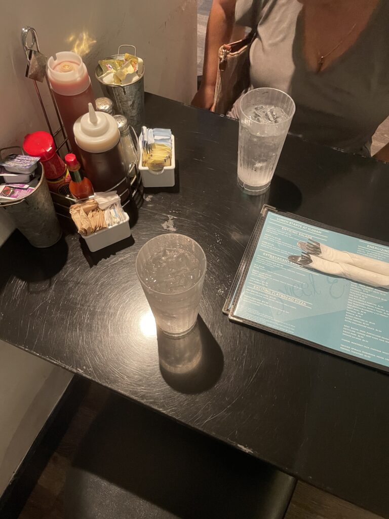 Review: Good Eats At Sweet E's Cafe Hawaii Calling a table with a glass of water and a menu