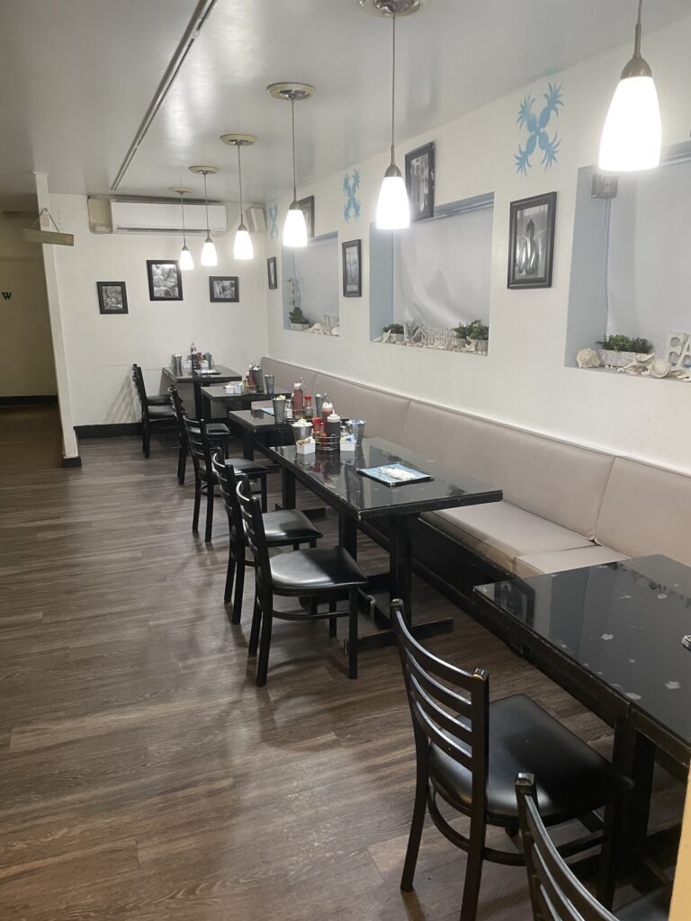 Review: Good Eats At Sweet E's Cafe Hawaii Calling a long table with chairs and a bench in a restaurant