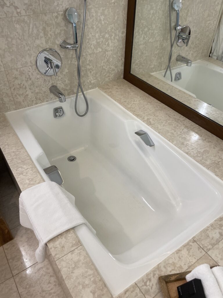 Review & Video: Four Seasons Oahu at Ko Olina, Pinnacle of Luxury Hawaii Calling a bathtub with a shower head and a mirror