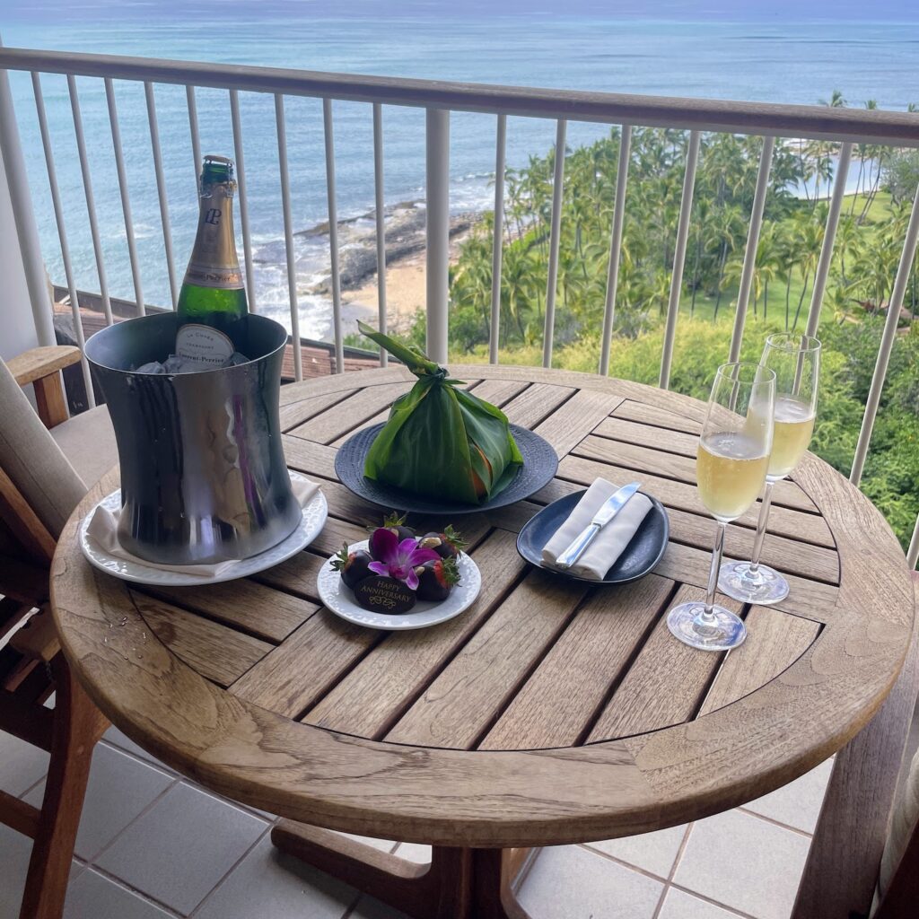 Review & Video: Four Seasons Oahu at Ko Olina, Pinnacle of Luxury Hawaii Calling a table with food and drinks on a balcony overlooking the ocean