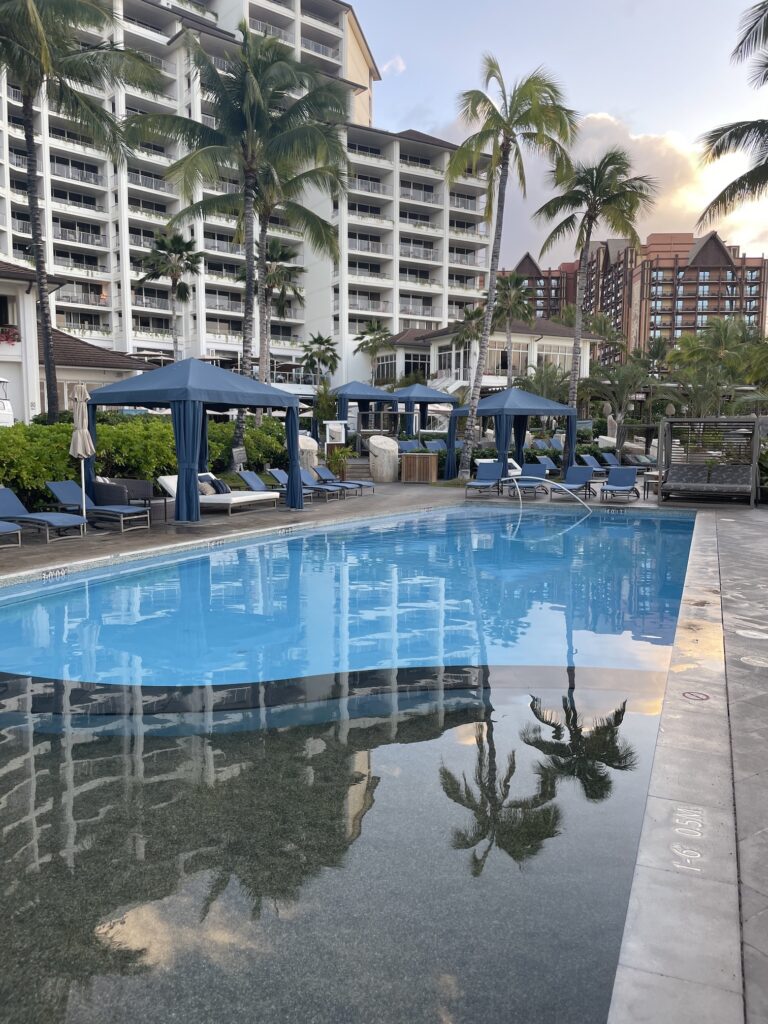 Review & Video: Four Seasons Oahu at Ko Olina, Pinnacle of Luxury Hawaii Calling a pool with lounge chairs and umbrellas in front of a building