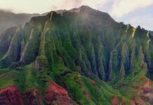 10 Essential Things to Pack For Your Trip To Hawai’i a green mountain with sand and water