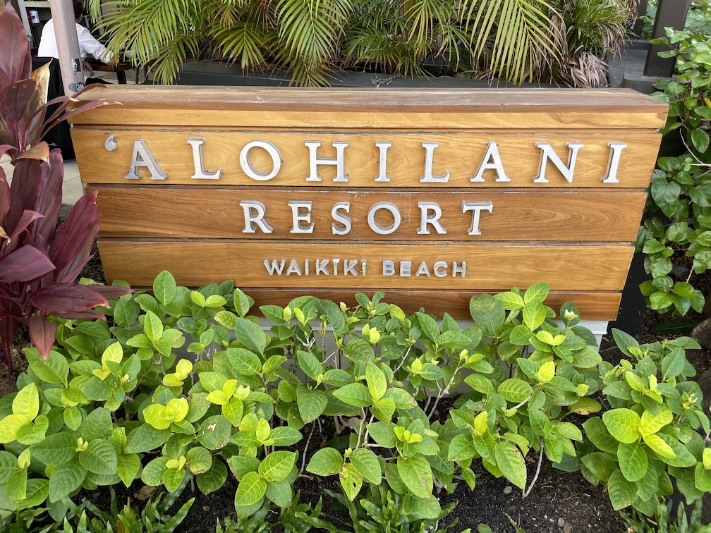 The 15 Best Hotels On Oahu For Families 2025 Hawaii Calling a sign with white letters and green plants