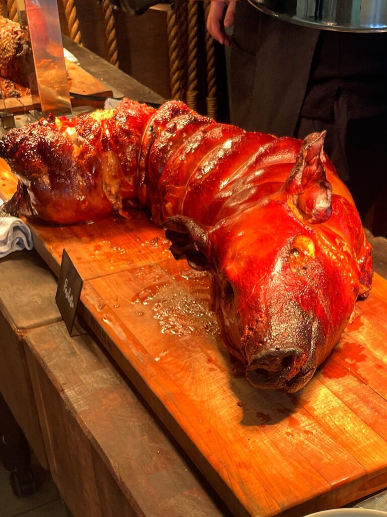 Delightful La Hiki Sunday Brunch | Four Seasons Oahu Hawaii Calling A full suckling pig roasted and sitting on 2 cutting boards at the La Hiki Sunday brunch.
