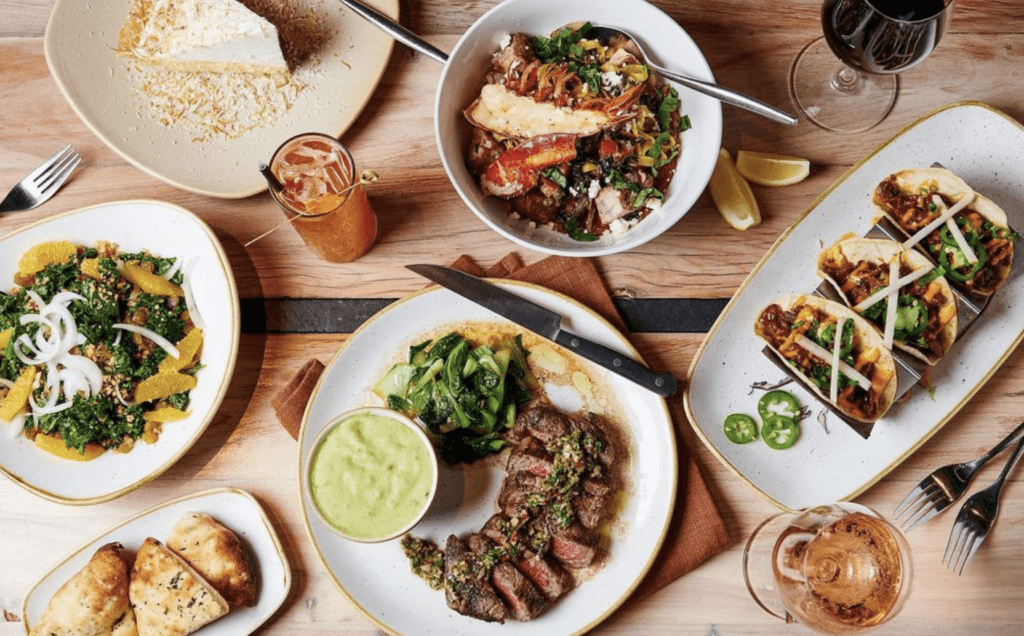 10 Best Maui Restaurants | Dining Guide for (2025) Hawaii Calling a table with plates of food