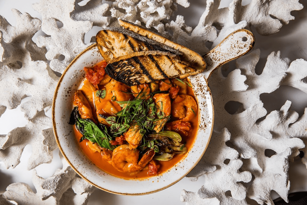 10 Best Maui Restaurants | Dining Guide for (2025) Hawaii Calling a bowl of soup with bread on a white surface