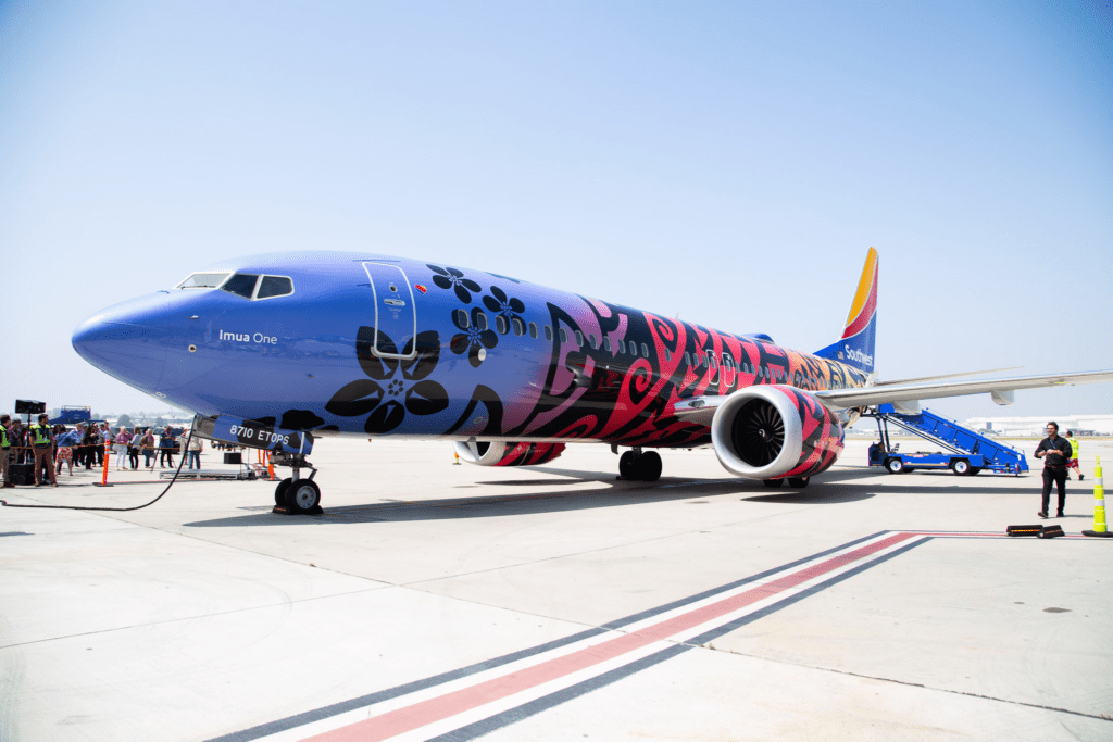 Hawaii Travel News May 2023 Hawaii Calling a blue and red airplane with flowers painted on it