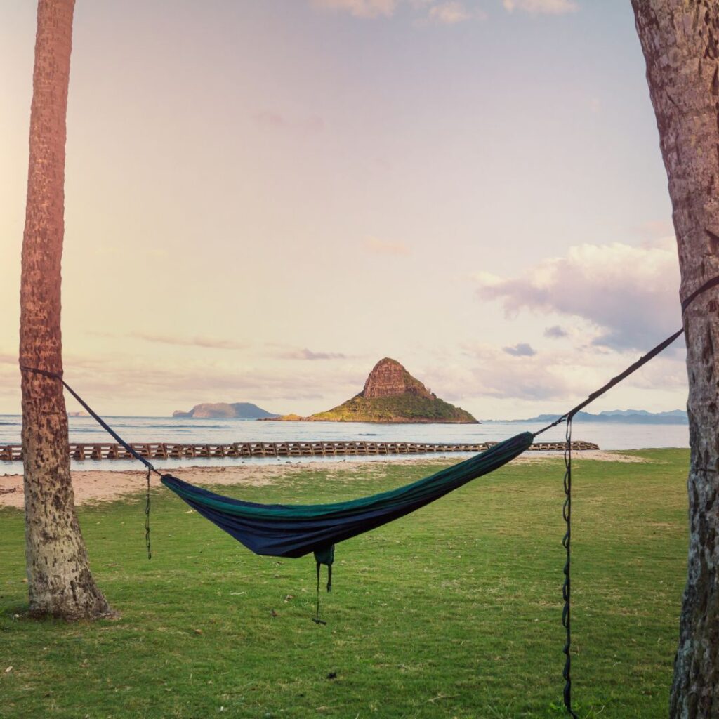 Best Places To Stay In Hawaii (2025)| A Hotel & Island Guide Hawaii Calling a hammock between two trees on a beach