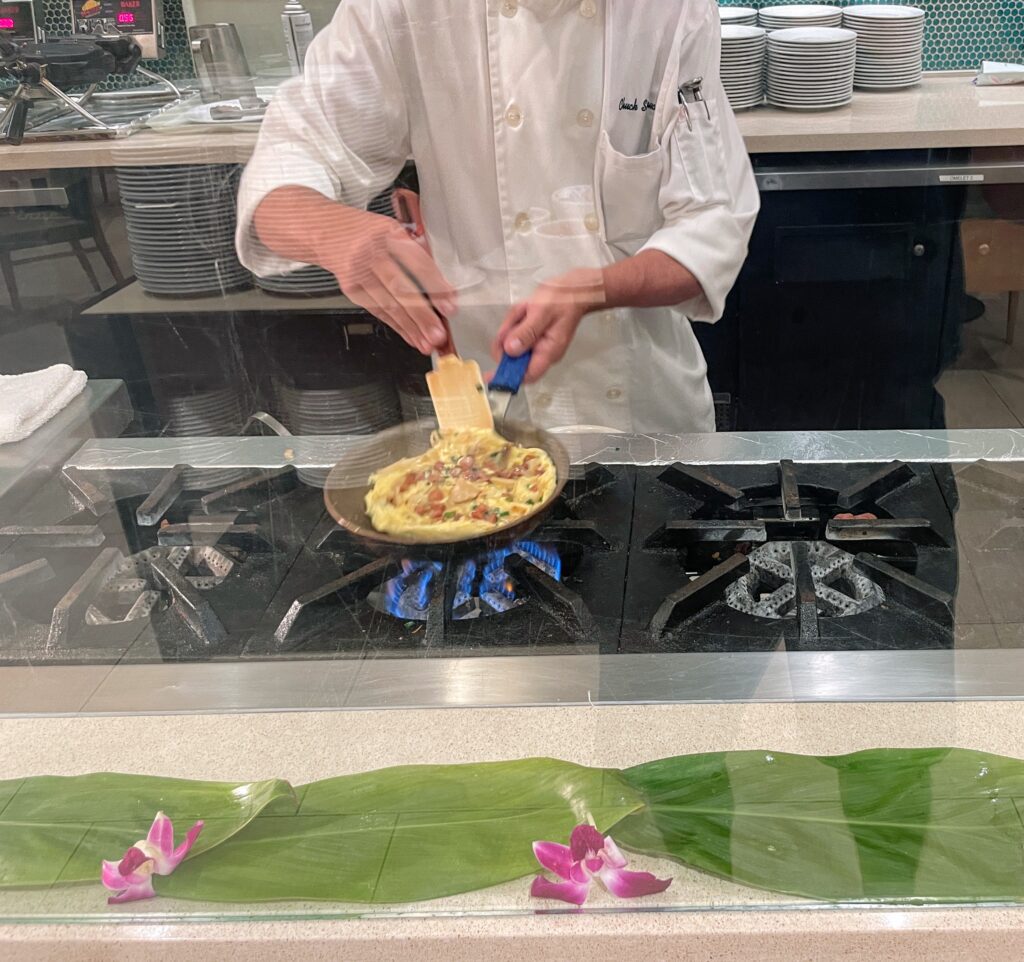 11 Best Sunday Brunch Buffets On Oahu Hawaii Calling a chef cooking food on a stove