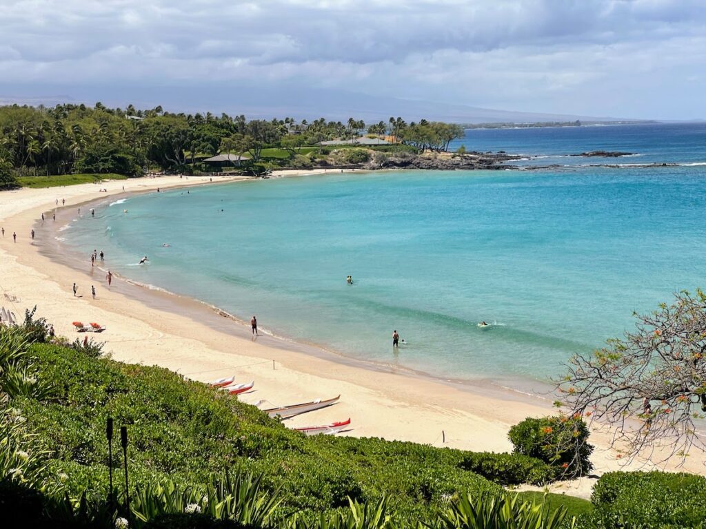 Best Places To Stay In Hawaii (2025)| A Hotel & Island Guide Hawaii Calling a beach with people on it near the Mauna Kea Beach Hotel, one of the Best Places To Stay In Hawaii