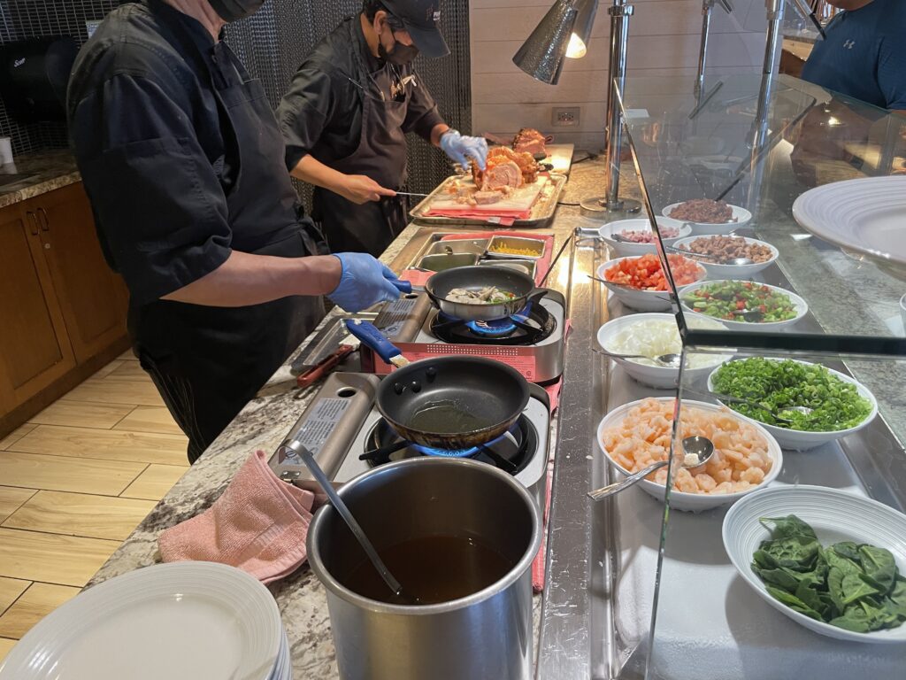 11 Best Sunday Brunch Buffets On Oahu Hawaii Calling a group of people cooking food