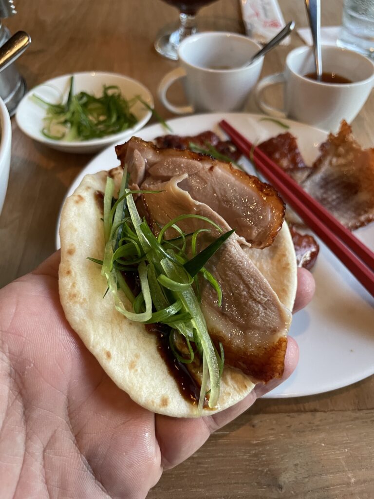 26 Best Places To Eat On Oahu, Hawaii | A Local Guide Hawaii Calling a hand holding a taco with meat and vegetables on it
