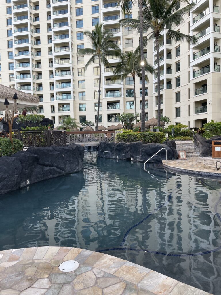Review & Video | Marriott Ko Olina Beach Club An Amazing Location Hawaii Calling a pool with rocks and palm trees in front of a building