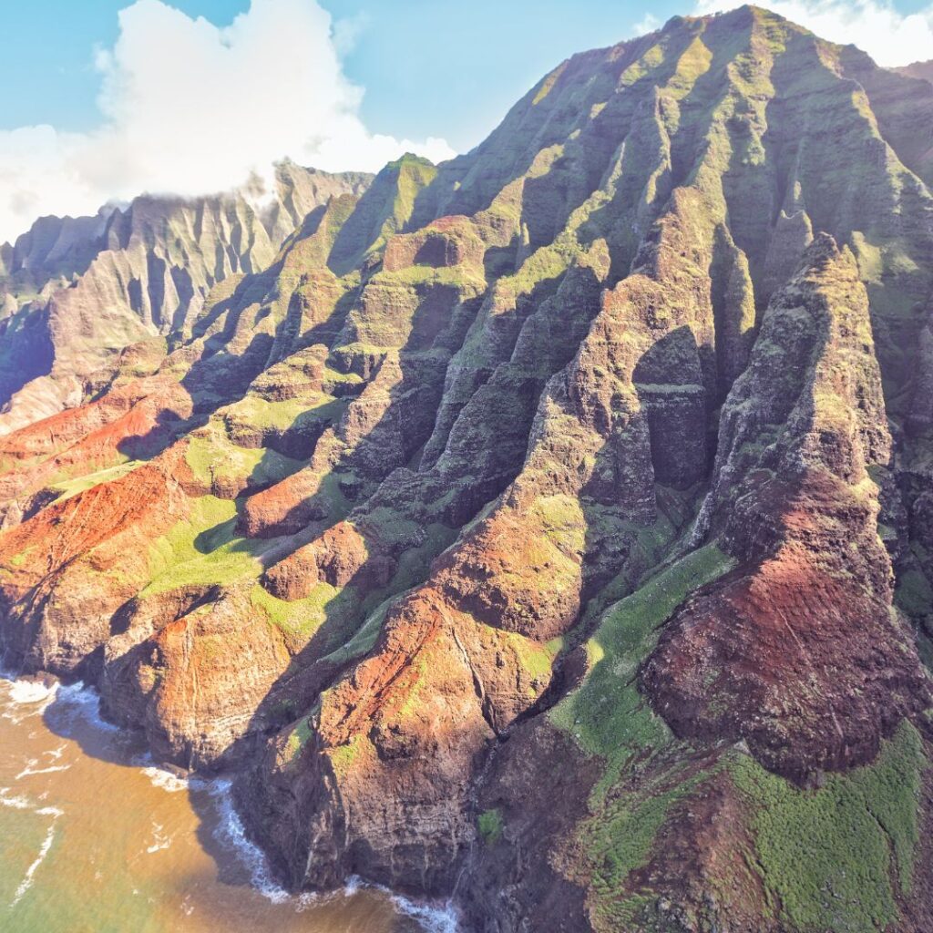 The 30 Best Things To Do On Kauai | A Bucket List Guide (2025) Hawaii Calling a large mountain with green and brown cliffs