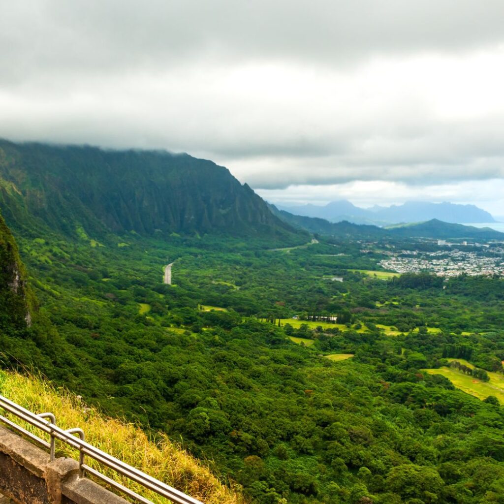 The 41 Best Things To Do On Oahu | Bucket List Guide (2025) Hawaii Calling a road leading to a valley with Nu‘uanu Pali in the background