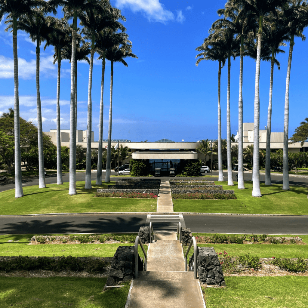 Top 6 Luxury Hotels On The Big Island Hawaii Calling a walkway leading to a building with palm trees