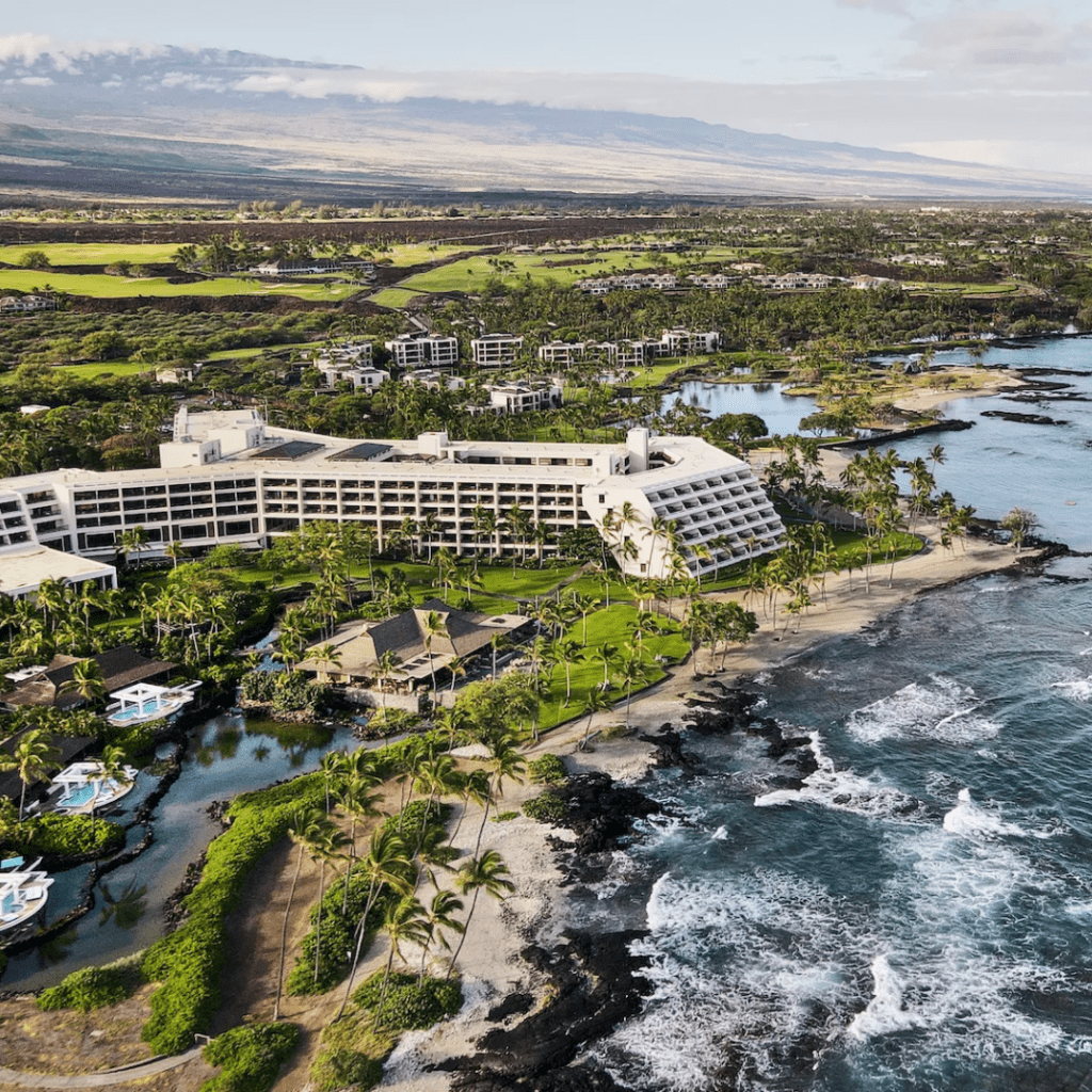 Top 6 Luxury Hotels On The Big Island Hawaii Calling a large hotel next to a body of water