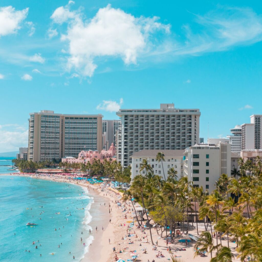 Best Places To Stay In Hawaii (2025)| A Hotel & Island Guide Hawaii Calling a beach with many people and buildings