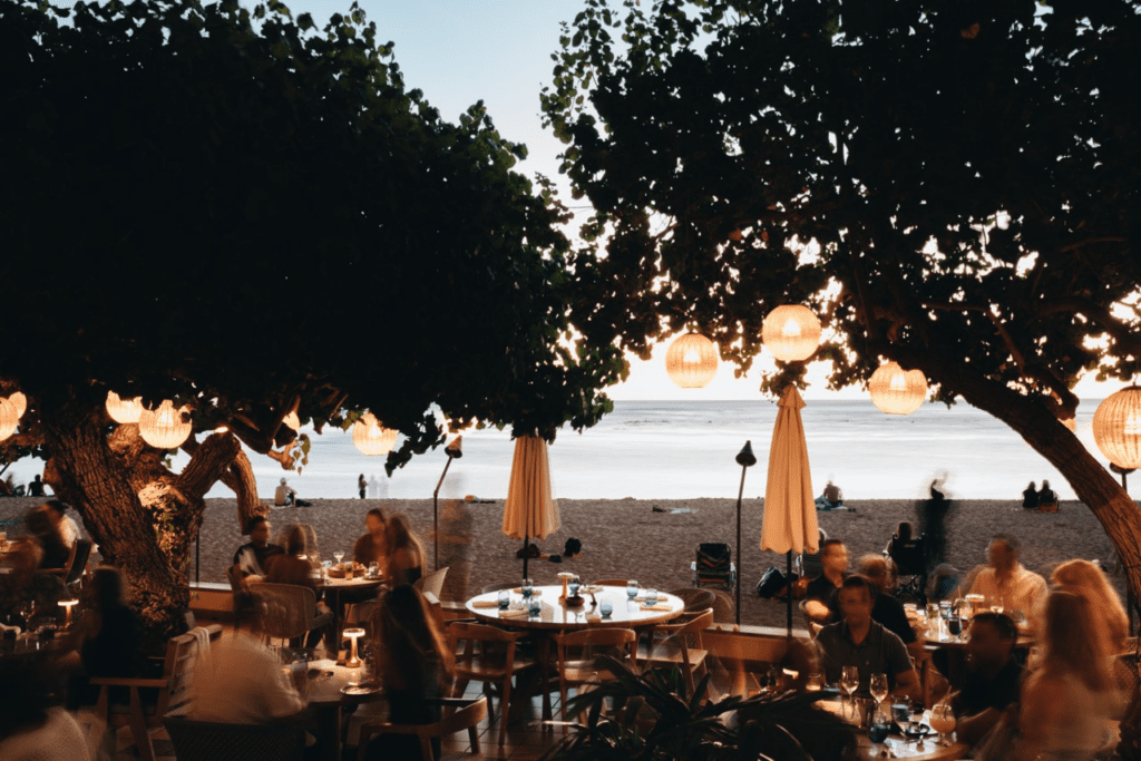 Relaxed Oceanside Hau Tree Brunch Review Hawaii Calling a group of people sitting at tables on a beach