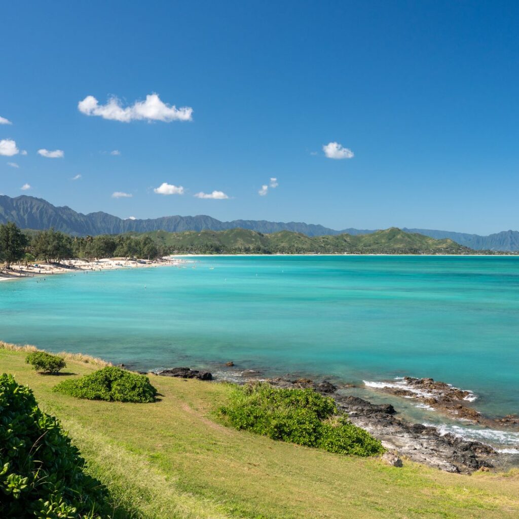 The 41 Best Things To Do On Oahu | Bucket List Guide (2025) Hawaii Calling a beach with trees and mountains in the background