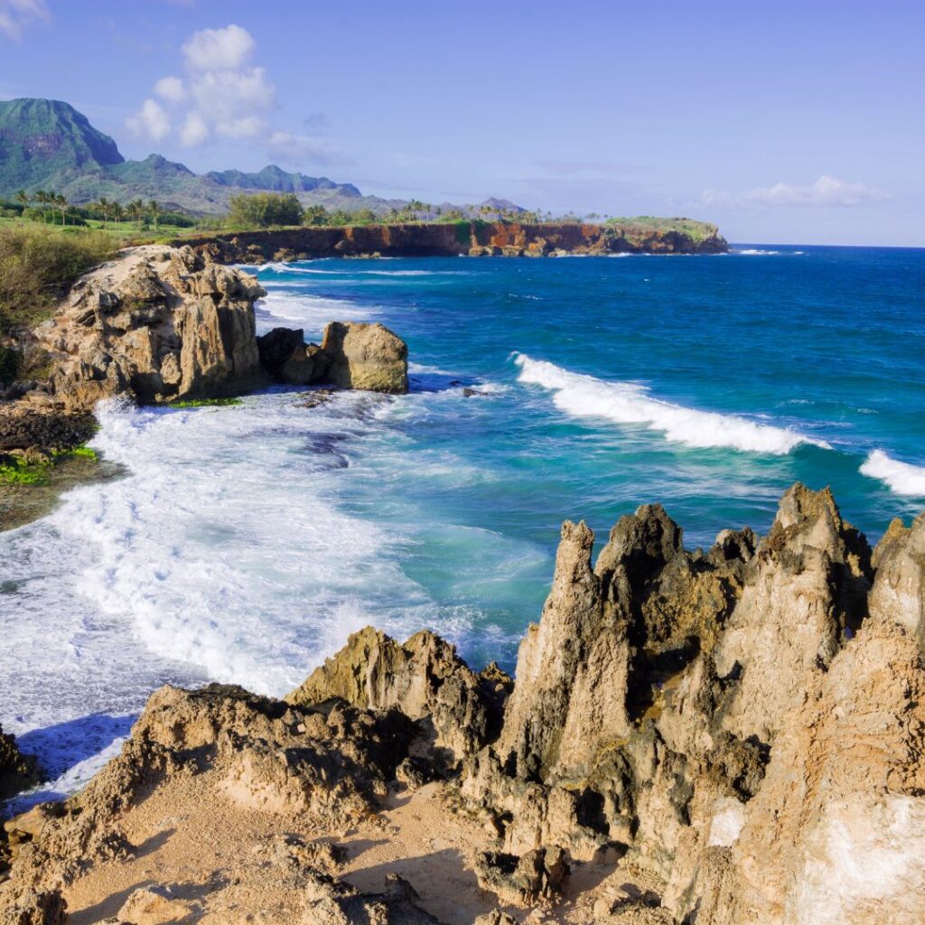 The 30 Best Things To Do On Kauai | A Bucket List Guide (2025) Hawaii Calling a rocky beach with waves crashing on the shore