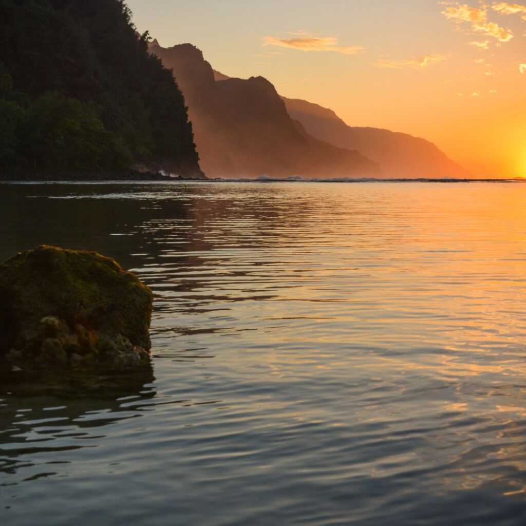 The 30 Best Things To Do On Kauai | A Bucket List Guide (2025) Hawaii Calling a sunset over a body of water